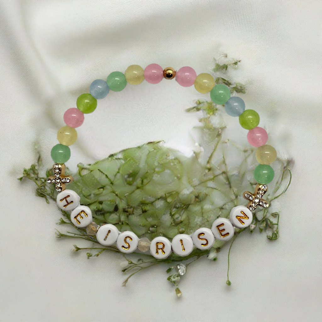 Bracelet with 'HE IS RISEN' beads on a white background